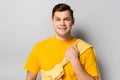 Cheerful man holding yellow pullover on Royalty Free Stock Photo