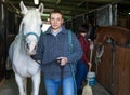 Cheerful man horse farm worker Royalty Free Stock Photo