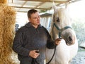 Cheerful man horse farm worker Royalty Free Stock Photo