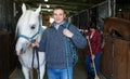 Cheerful man horse farm worker Royalty Free Stock Photo