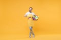 Cheerful man househusband in apron rubber gloves doing housework isolated on yellow background. Housekeeping concept