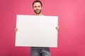 cheerful man posing with empty board, isolated Royalty Free Stock Photo