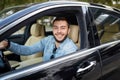 Cheerful man is rejoicing at buying a new car Royalty Free Stock Photo