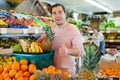 Cheerful man standing with full shopping cart during shopping Royalty Free Stock Photo