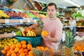 Cheerful man standing with full shopping cart during shopping Royalty Free Stock Photo