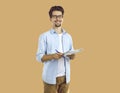 Cheerful man student or young professor standing with notebook and pen Royalty Free Stock Photo