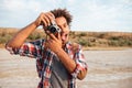 Cheerful man taking pictures and having fun on the beach Royalty Free Stock Photo