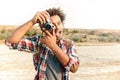 Cheerful man taking pictures and having fun on the beach Royalty Free Stock Photo