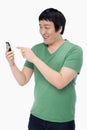 Cheerful man text messaging with his mobile phone Royalty Free Stock Photo