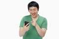 Cheerful man text messaging with his mobile phone Royalty Free Stock Photo