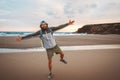 Cheerful man tourist outdoor with backpack walking alone on the beach travel lifestyle active summer vacations Royalty Free Stock Photo