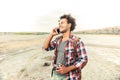 Cheerful man with vintage photo camera talking on cell phone Royalty Free Stock Photo