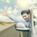 Cheerful man waving hand in the car Royalty Free Stock Photo