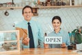 Cheerful man and woman advertising their new start up