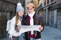 Cheerful man and woman with map