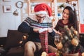 Man and woman opens Christmas gift at home Royalty Free Stock Photo