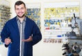 Cheerful man worker displaying result of his key making in works Royalty Free Stock Photo