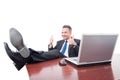 Cheerful manager with feet on desk