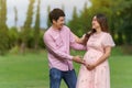 Cheerful married couple is expecting a baby. man embraces his pregnant wife in park Royalty Free Stock Photo