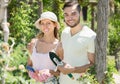 Cheerful married couple in flowers garden Royalty Free Stock Photo