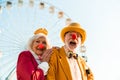 Cheerful mature couple having fun while walking in an amusement park Royalty Free Stock Photo