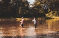 Cheerful mature fisherman fishing in a river outdoors. Successful catch. Men fishing on the lake. Fishing freshwater Royalty Free Stock Photo