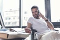 Cheerful mature man is talking on smartphone with pleasure Royalty Free Stock Photo