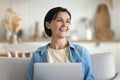 Cheerful mature woman spend time at home with laptop