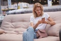 Mature woman using smart phone at furniture store Royalty Free Stock Photo