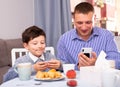 Cheerful man and his son with smartphones Royalty Free Stock Photo
