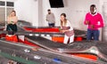 Men and women play with slot car racing track Royalty Free Stock Photo