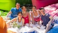 Cheerful men and women playing in foam pool in amusement park Royalty Free Stock Photo