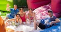 Cheerful men and women playing in foam pool in amusement park Royalty Free Stock Photo