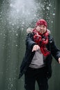 Cheerful middle age man in winter clothes throwing cloud of snow Royalty Free Stock Photo