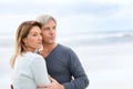 Cheerful middle-aged couple by the beach