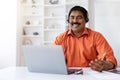 Cheerful middle aged eastern man working from home office Royalty Free Stock Photo