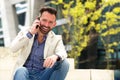 Cheerful middle aged man talking on mobile phone