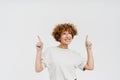 Cheerful middle-aged woman pointing fingers up at copyspace isolated Royalty Free Stock Photo