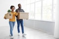 Cheerful millennial african american couple enjoying moving in new apartment, excited family in moving day Royalty Free Stock Photo