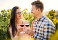 Cheerful millennial caucasian couple tasting wine together on a wineyard - Harvesting, wine tasting and vinification outdoor Royalty Free Stock Photo