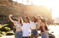 Cheerful millennial international people students enjoy summer holidays, have fun, taking selfie on smartphone Royalty Free Stock Photo