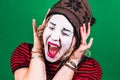 Girl mime posing and grimacing in photo studio Royalty Free Stock Photo