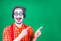 Cheerful mime posing near a green background Royalty Free Stock Photo