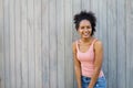 Cheerful mixed race woman standing outdoors