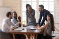 Cheerful mixed race young business partners enjoying break time. Royalty Free Stock Photo