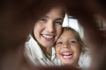 Cheerful mom and happy daughter kid making hand heart frame Royalty Free Stock Photo