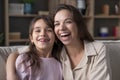 Cheerful mom hugging cute preschool kid girl looking at camera Royalty Free Stock Photo