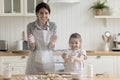 Cheerful mom and kid having fun, making mess in kitchen Royalty Free Stock Photo