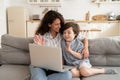 Mom and little kid greeting during video call on laptop wave hands to computer webcam smiling to dad