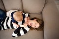 Cheerful mother and baby son playing on sofa at home Royalty Free Stock Photo